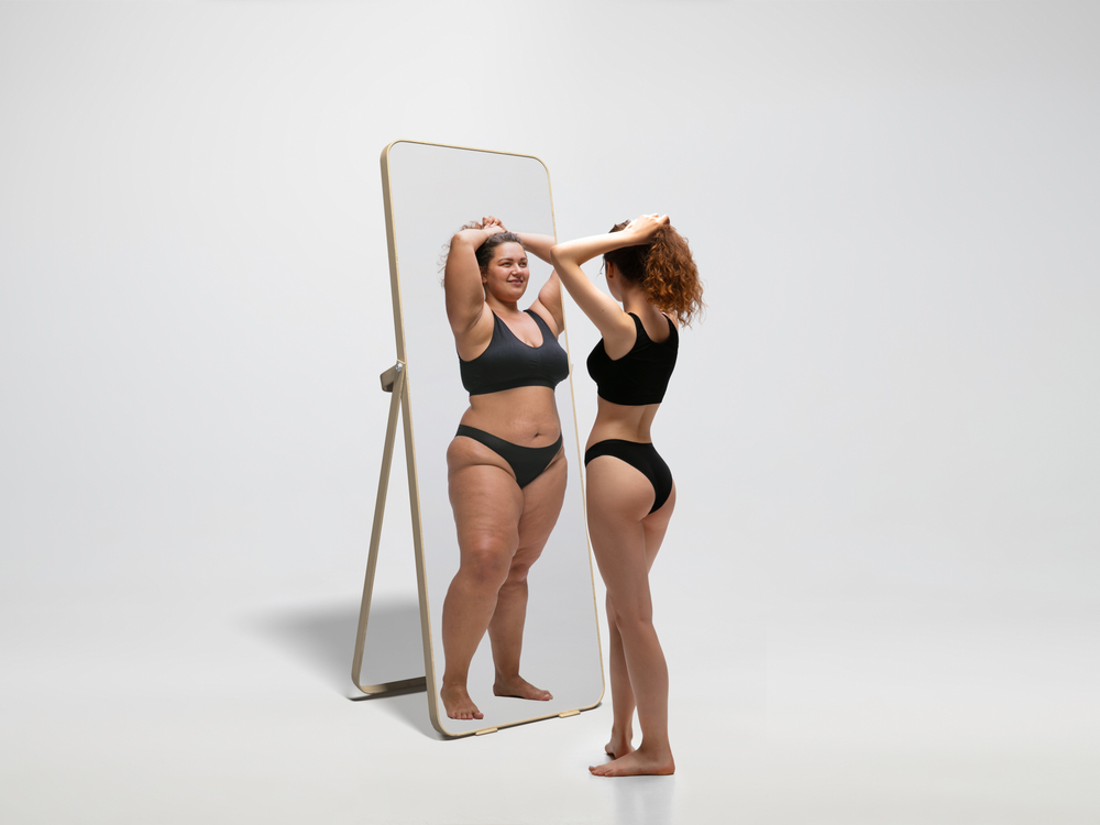 Young,Fit,,Slim,Woman,Looking,At,Fat,Girl,In,Mirror's