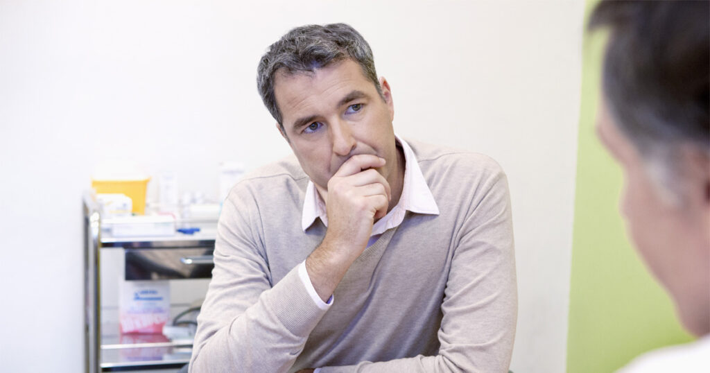 Man discussing testosterone replacement therapy benefits with healthcare provider